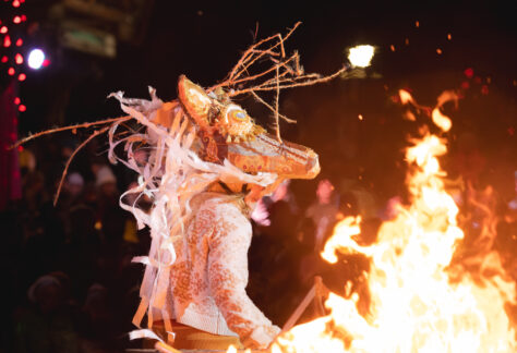 A community member dancing in costume.