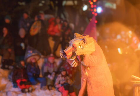 A performer circles the bonfire in their hand-made bear costume.