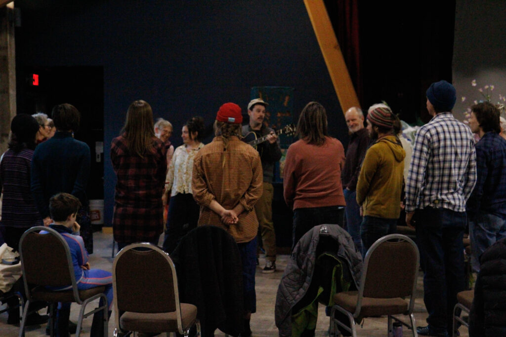 Community members learning to sing Wild Mountain Thyme for the upcoming winter festival.